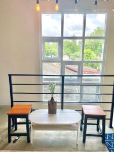 einem Tisch und zwei Bänken vor einem Fenster in der Unterkunft Rumah Paron Homestay Barat in Yogyakarta
