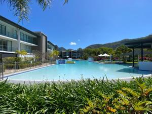 a large swimming pool in front of a building at Blue on Blue Studio Room 1272 in Nelly Bay