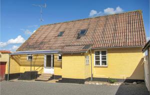 a yellow house with a brown roof at Stunning Home In Gudhjem With Kitchen in Gudhjem