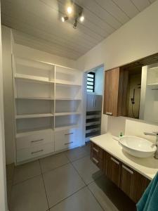 a bathroom with a sink and a mirror at Luxury beach house with spectacular sea view and pool in Trou aux Biches