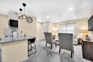 a kitchen and living room with a table and chairs at Cozy 2 Bedroom Pineville-Matthews Duplex Sleeps 8 in Charlotte