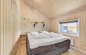 a bedroom with a bed in a room with a window at Awesome Home In Otterup With Kitchen in Otterup