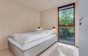 a small bedroom with a bed and a window at Lovely Home In Hovborg With Kitchen in Hovborg