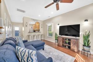 a living room with a blue couch and a flat screen tv at Cozy 2B Townhouse King Bed Free Parking TV in BRs in Concord