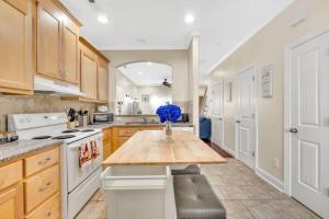 a kitchen with a table with a vase on it at Cozy 2B Townhouse King Bed Free Parking TV in BRs in Concord