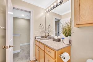 a bathroom with a sink and a mirror at Cozy 2B Townhouse King Bed Free Parking TV in BRs in Concord +19 photos