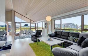 a living room with a couch and a table at Amazing Home In Hjørring With Sauna in Hjørring