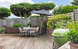 a patio with a table and an umbrella and a grill at Pet Friendly Home In Hejls With Wifi in Hejls +18 photos