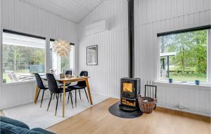 a dining room with a table and a wood stove at 3 Bedroom Pet Friendly Home In Ålbæk in Ålbæk
