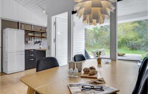 a kitchen and dining room with a table and chairs at 3 Bedroom Pet Friendly Home In Ålbæk in Ålbæk +10 photos