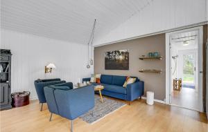 a living room with two blue couches and a table at 3 Bedroom Pet Friendly Home In Ålbæk in Ålbæk