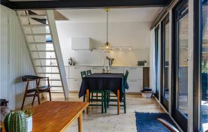 a kitchen and dining room with a table and chairs at Awesome Home In Aakirkeby With Wifi in Vester Sømarken