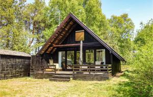 a small house with a gambrel roof at Awesome Home In Aakirkeby With Wifi in Vester Sømarken +11 photos