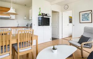 a kitchen and living room with a table and chairs at Awesome Apartment In Allinge With Wifi in Allinge