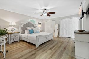 een slaapkamer met een wit bed en een plafondventilator bij Cozy Lake Home - Jacuzzi King Bed Marina Access in Mooresville
