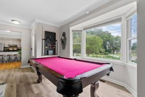 a pool table in a room with a large window at Cozy Lake Home - Jacuzzi King Bed Marina Access in Mooresville
