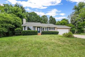 a house with a garage and a grass yard at Cozy Lake Home - Jacuzzi King Bed Marina Access in Mooresville