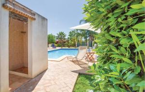 a swimming pool with a chair and an umbrella at Villa Gina in Menfi +15 photos