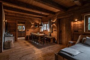 a room with a table and chairs in a cabin at Luxury old wood mountain chalet in a sunny secluded location with gym, sauna & whirlpool in Scheffau am Wilden Kaiser +51 photos