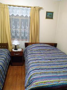 a bedroom with two beds and a window at Casa en algarrobo in Algarrobo