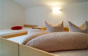 two beds with checkered pillows in a room at Stunning Home In Hippach-schwendberg With Wifi And 5 Bedrooms in Grün