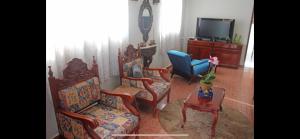 オリンピアにあるNova casa da vovó duduのリビングルーム(椅子3脚、テレビ付)