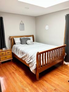 a bed in a bedroom with a wooden floor at Shore house on Pelican Island! in Seaside Heights