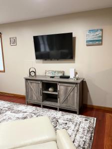 a living room with a flat screen tv on a wall at Shore house on Pelican Island! in Seaside Heights