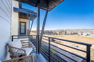 a balcony with a chair and a view of the beach at Modern Upscale Townhouse in Park City in Park City