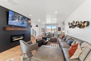 a living room with a couch and a tv at Modern Upscale Townhouse in Park City in Park City