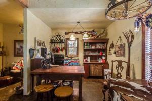 a living room with a table and some chairs at Last Outpost Bandera Ranch House in Bandera