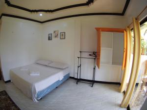 una camera con letto e doccia di Villa Consolacion Resort a General Luna
