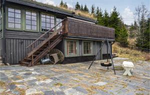 a house with a staircase in front of it at 3 Bedroom Nice Home In Hurdal in Hurdal