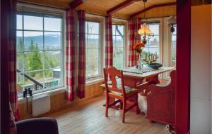 a dining room with a table and some windows at 3 Bedroom Nice Home In Hurdal in Hurdal