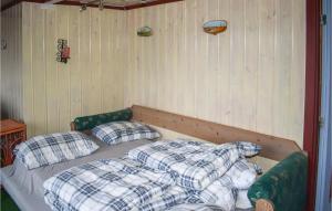a bed with two pillows in a room at 3 Bedroom Nice Home In Hurdal in Hurdal