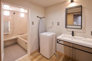 a bathroom with a sink and a toilet and a tub at Large family accommodation Tsuji family - Vacation STAY 20952v in Mitoyo