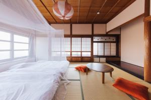 a bedroom with a bed and a table in it at Large family accommodation Tsuji family - Vacation STAY 20952v in Mitoyo