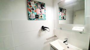 a white bathroom with a sink and a mirror at ☆WOW! Stylish Studio in Centre Near University☆ in Mannheim