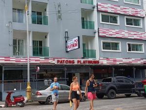 a group of people walking down a street in front of a building at Patong Platinums Phuket in Patong Beach