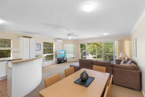 a living room with a couch and a table at Rivershores in Noosaville