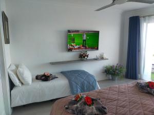 a room with two beds and a television on the wall at Playa Monis 1 in Icod de los Vinos