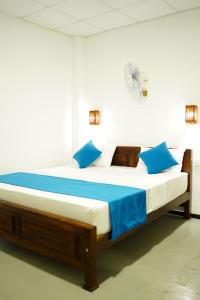 a bed in a room with blue pillows at Blue Ocean - Private Villa 03 BR in Tangalle