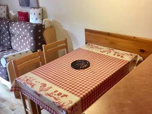 a table with a red and white table cloth on it at Appartement Les Angles, 2 pièces, 4 personnes - FR-1-295-149 in Les Angles