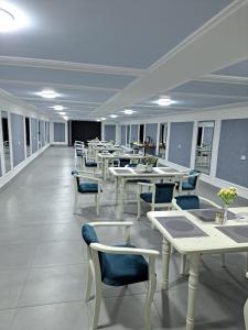 a dining room with tables and chairs in a room at LIANALI HOTEL in Bukhara