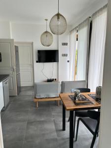 a living room with a table and a couch at CAPLINE in Saint-Benoît