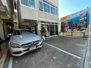 a car parked in a parking lot in front of a building at Studio'Z in Chiang Mai