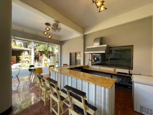 a kitchen with a bar with chairs and a table at Studio'Z in Chiang Mai