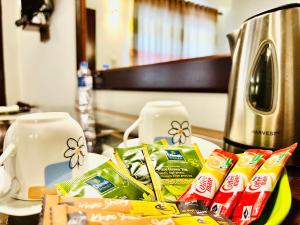 a counter top with a pile of food and a coffee maker at Cozy Sea view Inn in Hikkaduwa