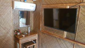 a television hanging on a wall in a room at Paraiso Cave & Restaurant & Resort in San Francisco