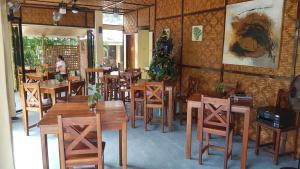 a restaurant with wooden tables and chairs and a christmas tree at Paraiso Cave & Restaurant & Resort in San Francisco